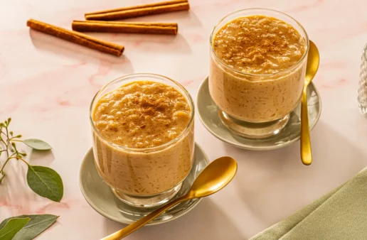 two glasses with arroz con leche served over two plates