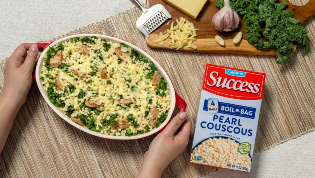 baked pearl couscous with chicken sausage, kale and gruyere